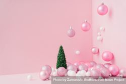 Baubles in a variety of pink shades in corner of pink room with Christmas tree 0Kg170