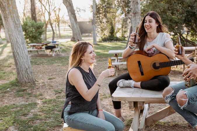Young musicians drinking beer in park