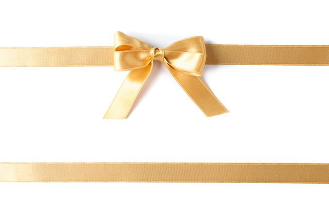 Golden ribbons with bow isolated on plain background. Gift concept