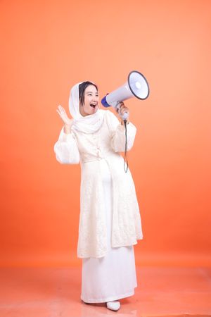 Exuberant Announcement, Woman with Megaphone on Orange Backdrop