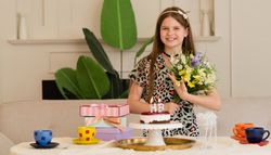 Girl enjoying birthday with flowers, cake and presents