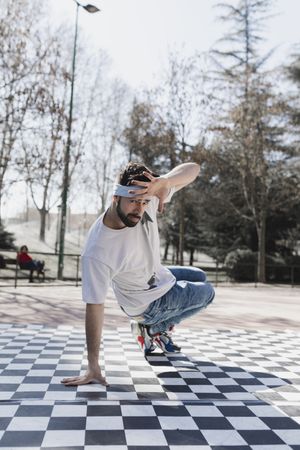 Man dancing break dance in park