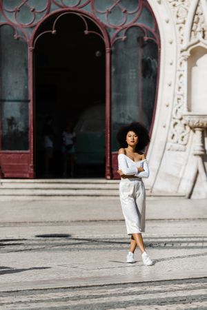 Young Black female standing on urban background
