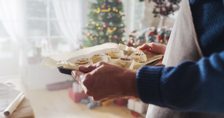 Close Up of a Male Preparing Making Cinnamon Buns for Christmas at Home.