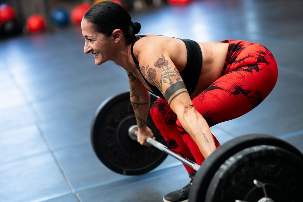 Close up of woman deadlifting bar bell