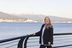Smiling woman standing near the water edge