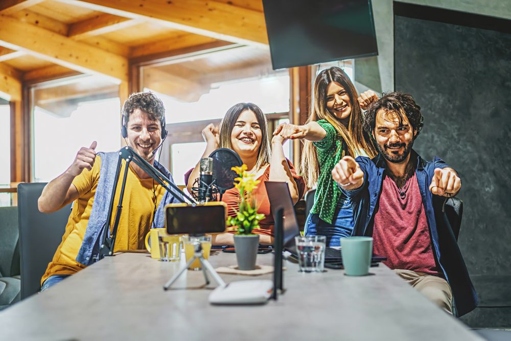 Millennial friends sharing vlog content on streaming platform with digital web camera