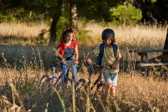 Children talking while riding bicycles