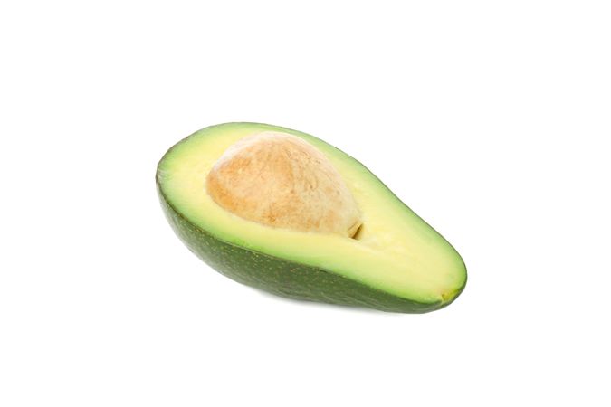 Half of ripe avocado isolated on blank background