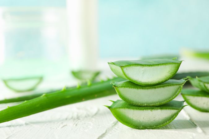 Aloe vera slices on wooden table, closeup and space for text. Natural treatment
