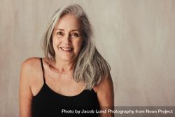 Closeup shot of an aging woman smiling while posing in her natural body 4ORQJ5