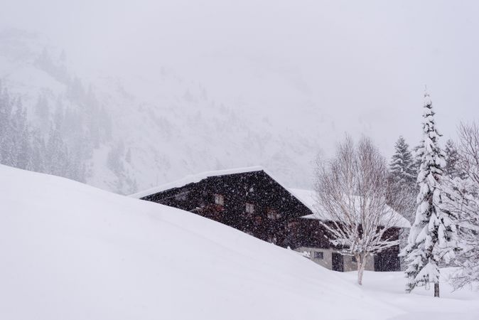 Alpine cabin on a blizzard surrounded by deep snow in the Bavarian Alps, Germany