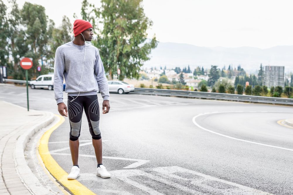 Fit male standing on city street