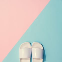 Painted flip flops with pastel pink and blue background