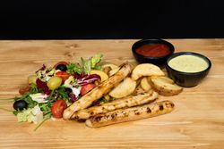 Fried meat and vegetables near ketchup