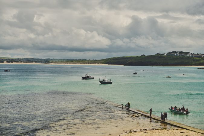 People and boats on a Cornish beach