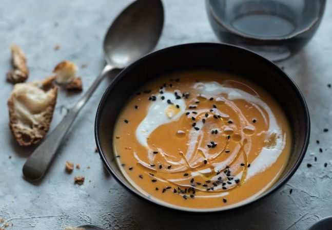 Bowls with pumpkin cream soup on table