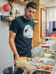 Young male working in Asian cafe