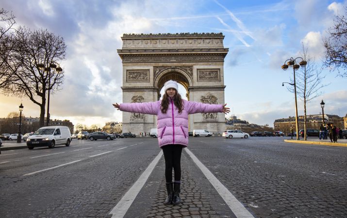 Girl standing against triumphal arch