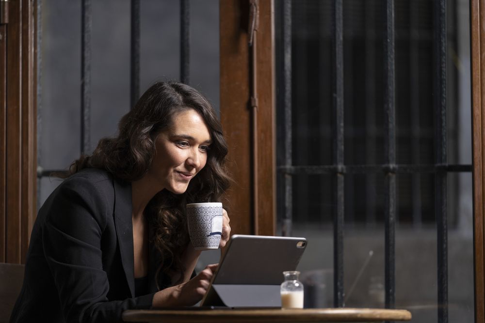 Young female using digital tablet in cafe