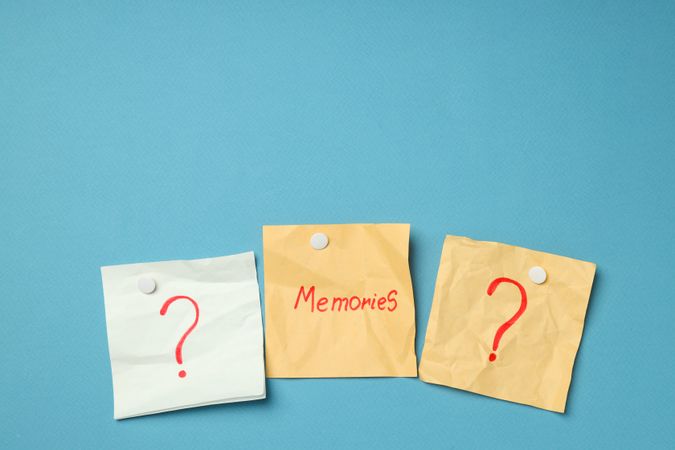Pinned post it notes with the word “memories” in blue room, copy space