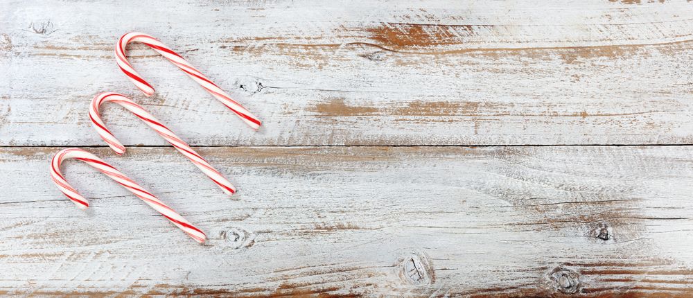 Christmas candy canes on rustic wooden background
