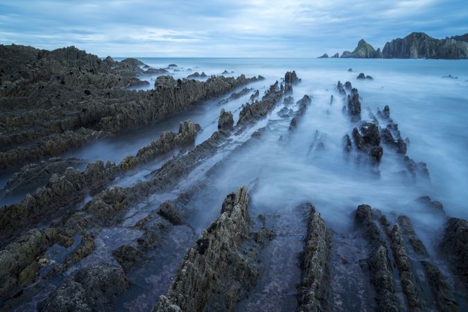 Foggy landscape of Playa de Gueirua rock seashore