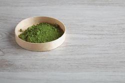 Matcha tea powder displayed in round box