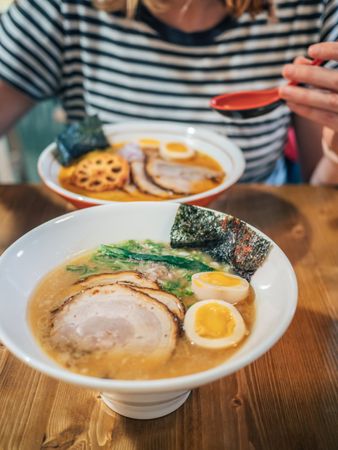 Female eating Japanese dish