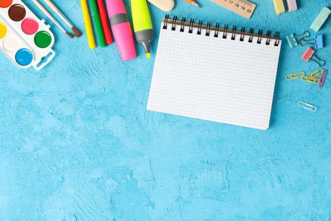 Flat lay composition with school supplies on color background, space for text