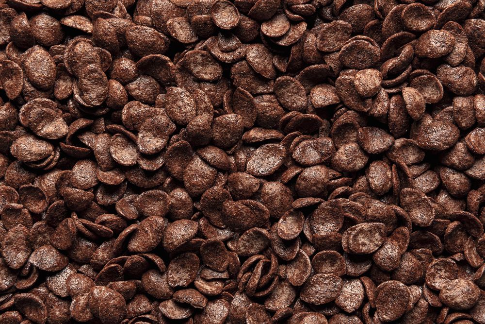 Chocolate cornflakes cereal, background, top view