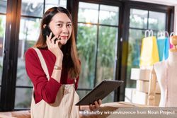 Female e-commerce business owner talking on her phone 49OMy0