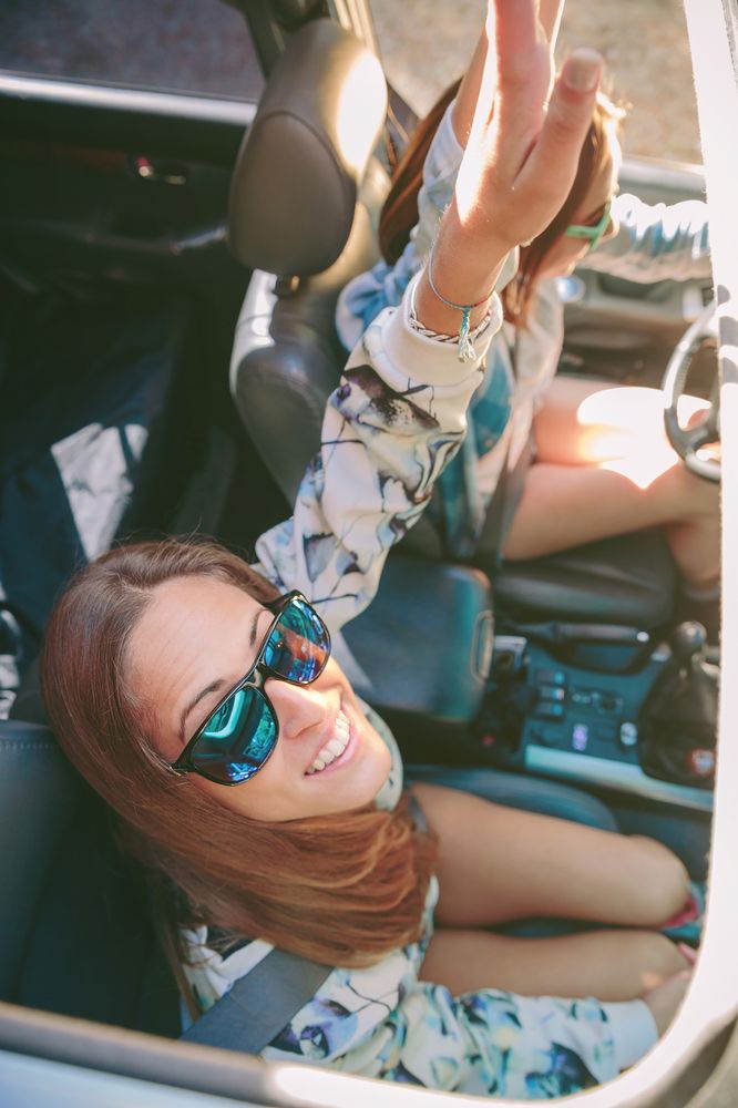 Happy women having fun inside of car