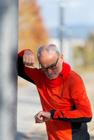 Older male checking watch before workout