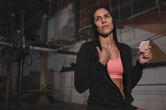 Smiling woman with rice cakes in gym