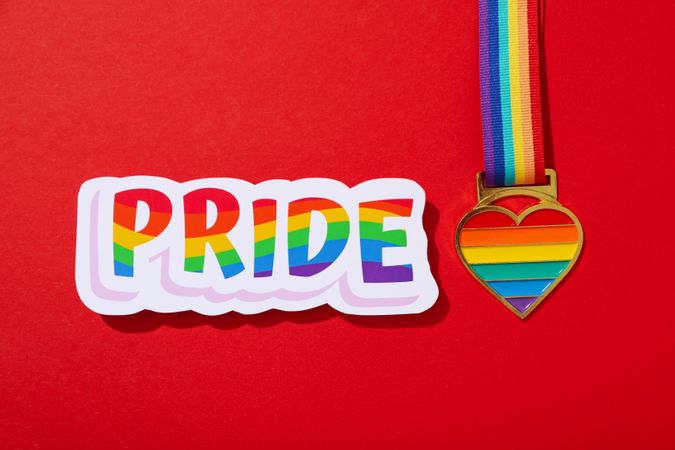 Pride parade concept, colorful symbols on red background.