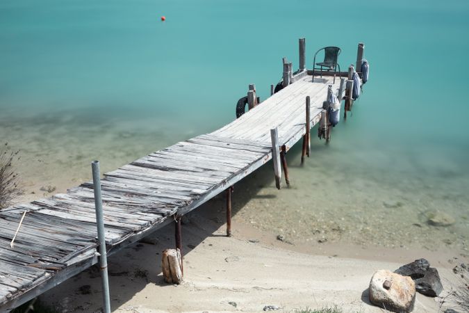 Wooden broken old pier in calm water