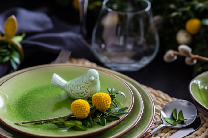 Green ceramic bird on plate for spring table setting