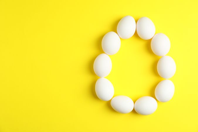 Flat lay composition with chicken eggs on color  background, space for text