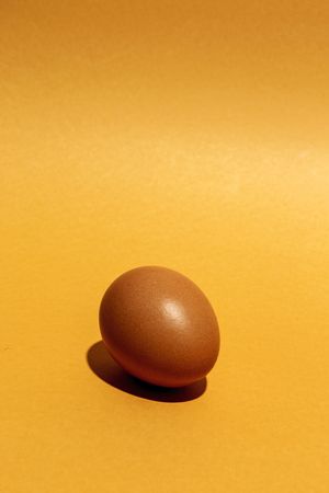 Fresh raw eggs on brown background
