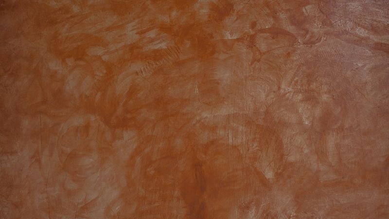 Brown painted wall with textured smudge and artistic brush strokes