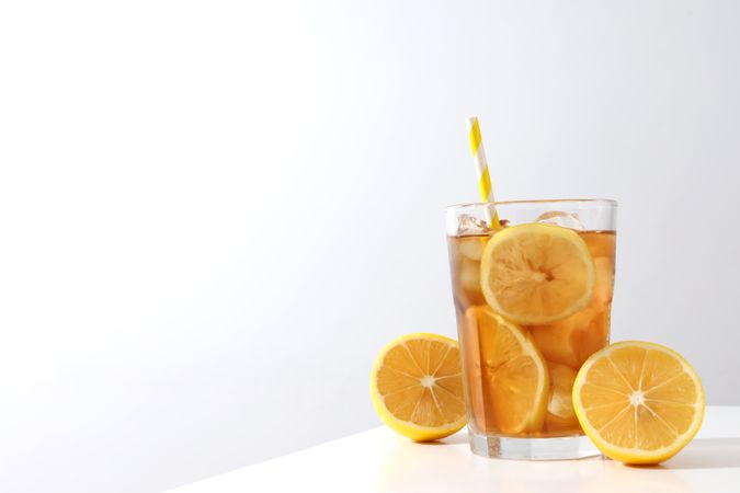 A glass of cold tea with fresh orange slices