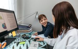 Woman teleworking at home talking with her son