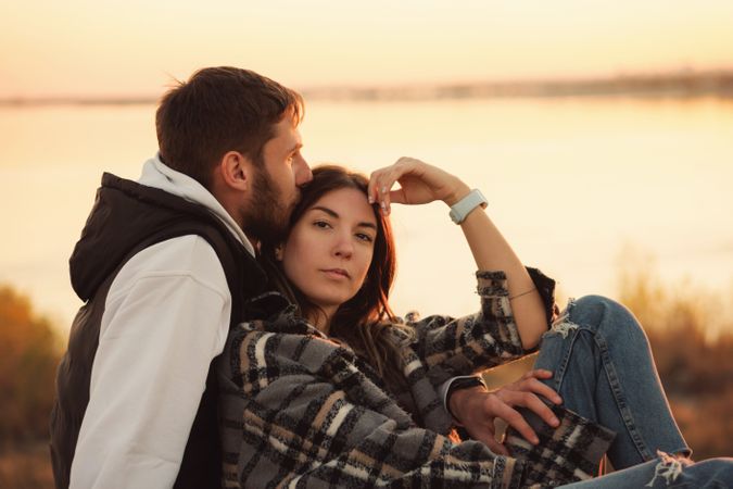 Couple sitting dusk countryside