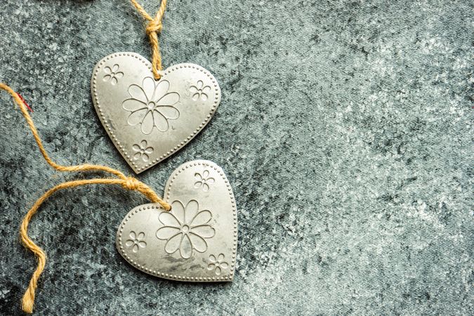 Valentine's day concept with close up of heart shaped ornaments on grey counter