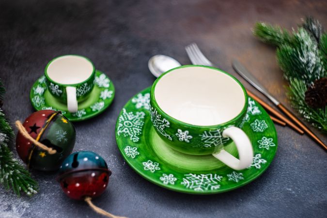 Two tea and saucers with green snowflakes for Christmas
