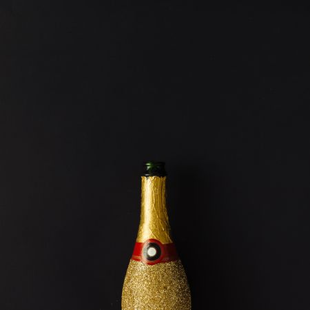 Golden champagne party bottle on background