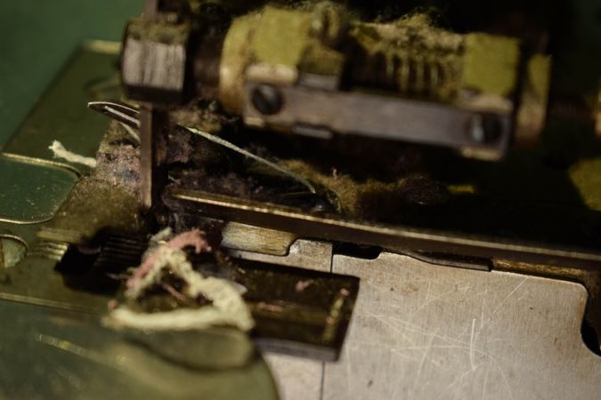 Close up of fabric strip tailor's bronze sewing machine