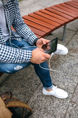 Unrecognizable young man using tablet