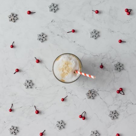 Snowflakes and berry on marble background with coffee